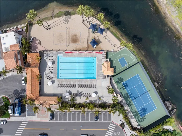 an aerial view of a house with a yard and wooden fence