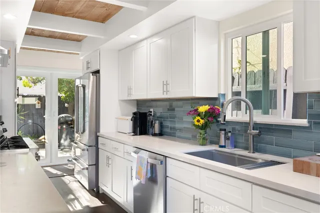 a kitchen with stainless steel appliances granite countertop sink and cabinets