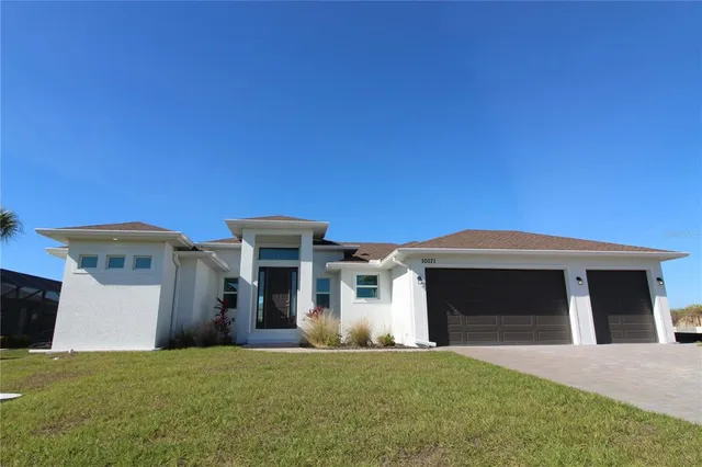 a front view of a house with a yard and garage