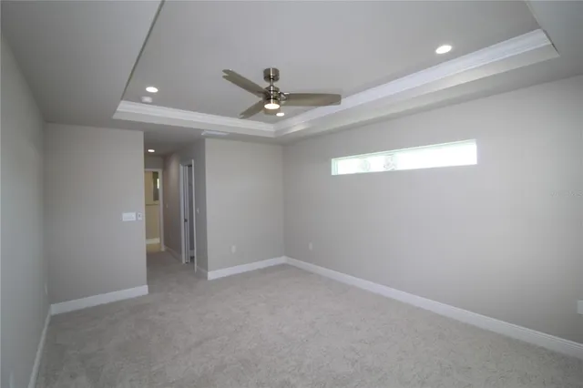 an empty room with a ceiling fan and a window