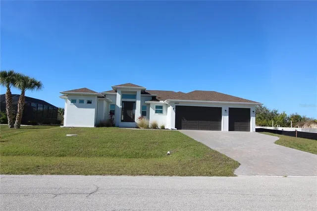 a front view of a house with a garden and yard