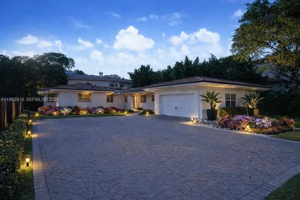 a couple of table and chairs in front of house