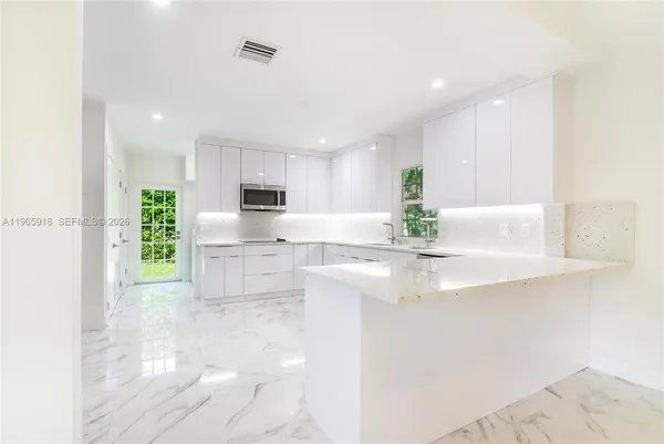 a view of kitchen with white cabinets