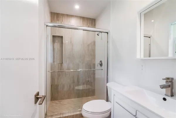 a white toilet sitting next to a bathroom sink