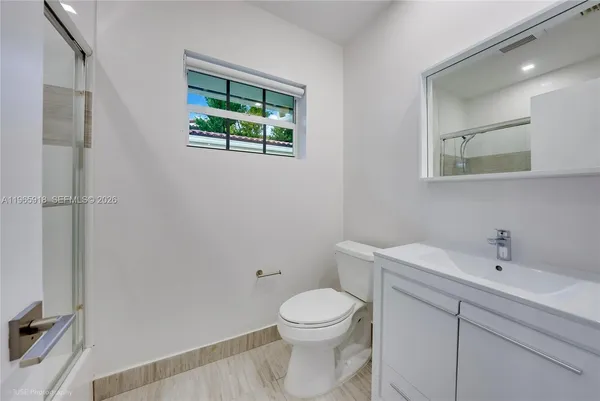 a bathroom with a sink toilet and shower