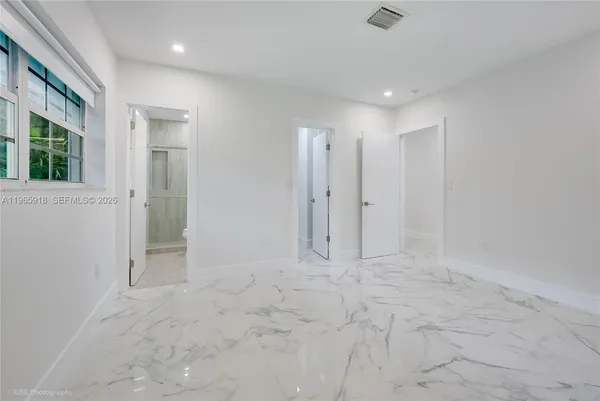a view of an empty room with a window