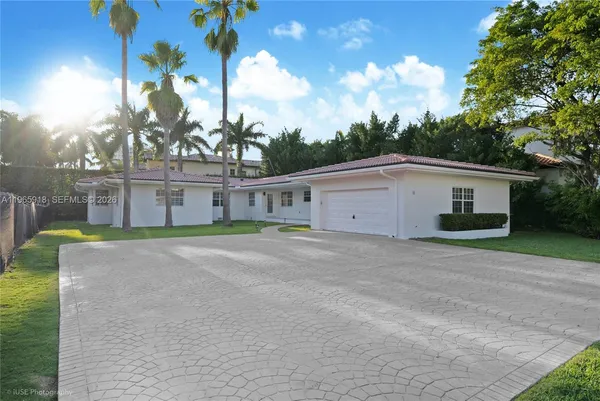 a view of a house with a yard and a garage