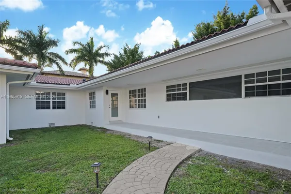 a front view of a house with a garden