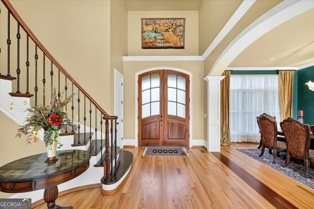 a living room with fireplace furniture and a large window