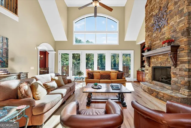a kitchen with stainless steel appliances granite countertop a sink a stove and a wooden cabinets