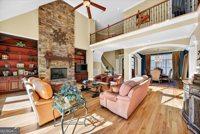 a living room with furniture and floor to ceiling windows