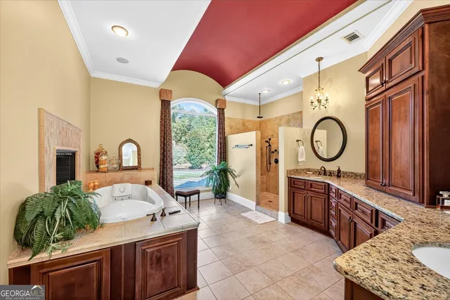 a bedroom with a bed and a tv on dresser