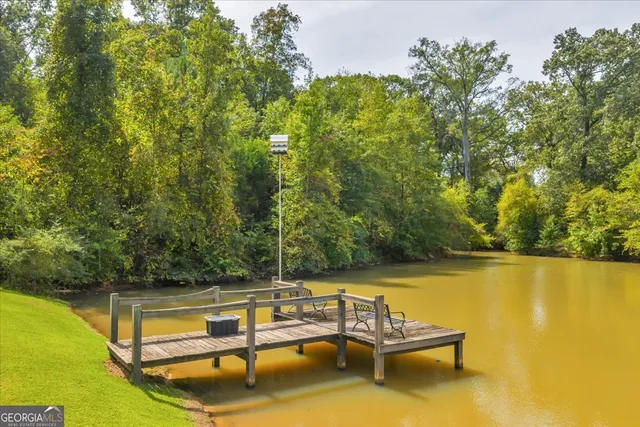 a view of hall way with furniture and wooden floor