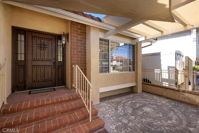 a view of a big room with wooden floor stairs and windows