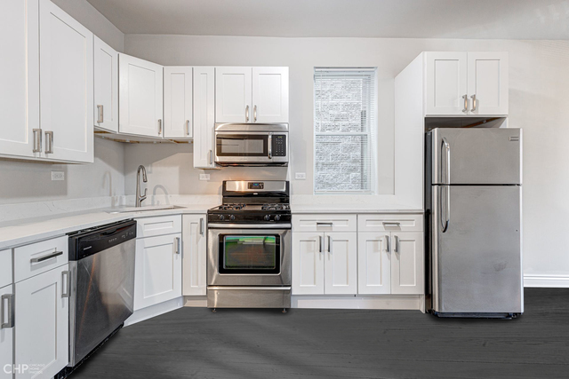 2633 West Haddon Avenue, Unit 3F Chicago, IL 60622 - Photo 5 of 12 a kitchen with cabinets stainless steel appliances and a window