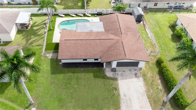 an aerial view of a house with a swimming pool