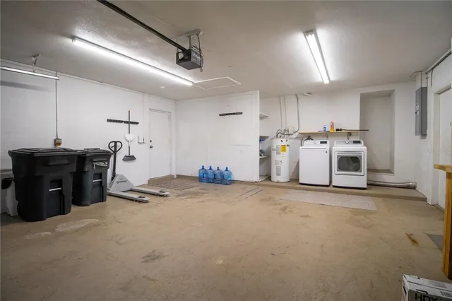 a view of a kitchen with refrigerator and white cabinets
