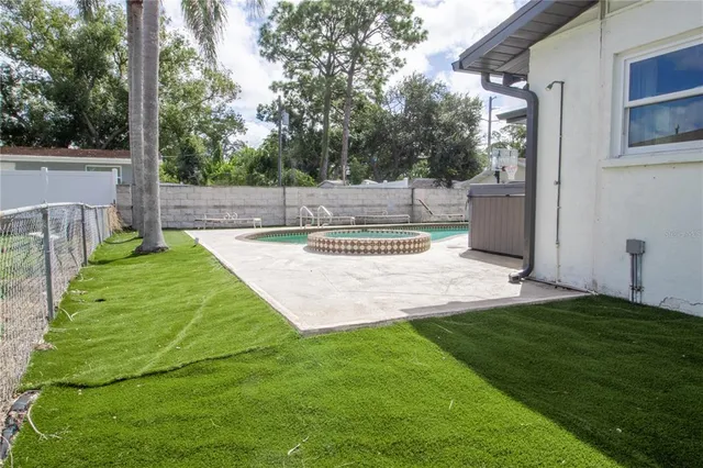 a view of a backyard with large tree