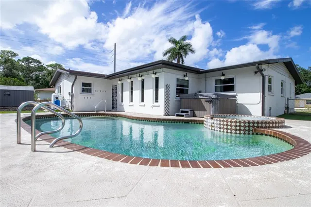 a view of a house with a yard porch and furniture