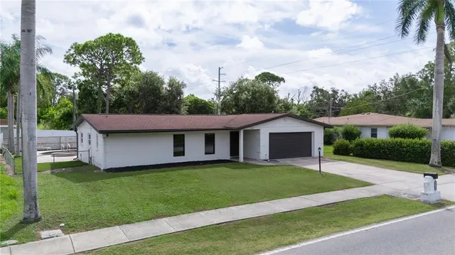 a view of a house with a yard and plants