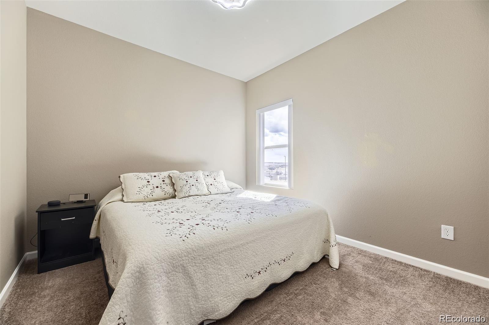 4807 River Highlands Loop Elizabeth, CO 80107 - Photo 12 of 37 a bedroom with a bed and a window