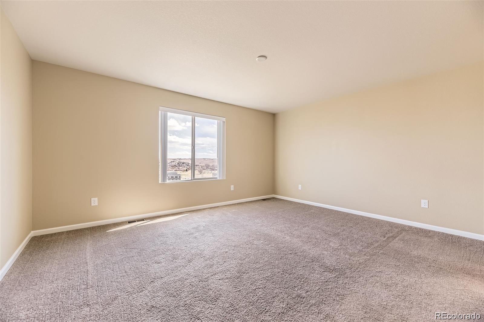 4807 River Highlands Loop Elizabeth, CO 80107 - Photo 14 of 37 an empty room with windows