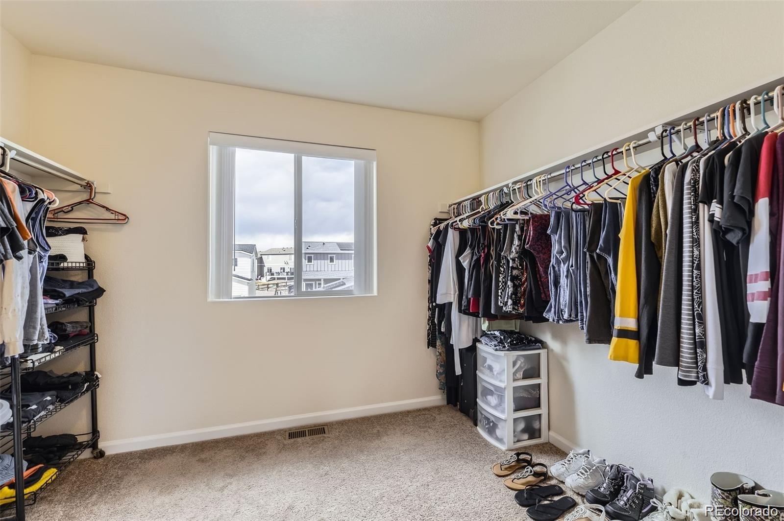 4807 River Highlands Loop Elizabeth, CO 80107 - Photo 18 of 37 a view of walk in closet with clothes