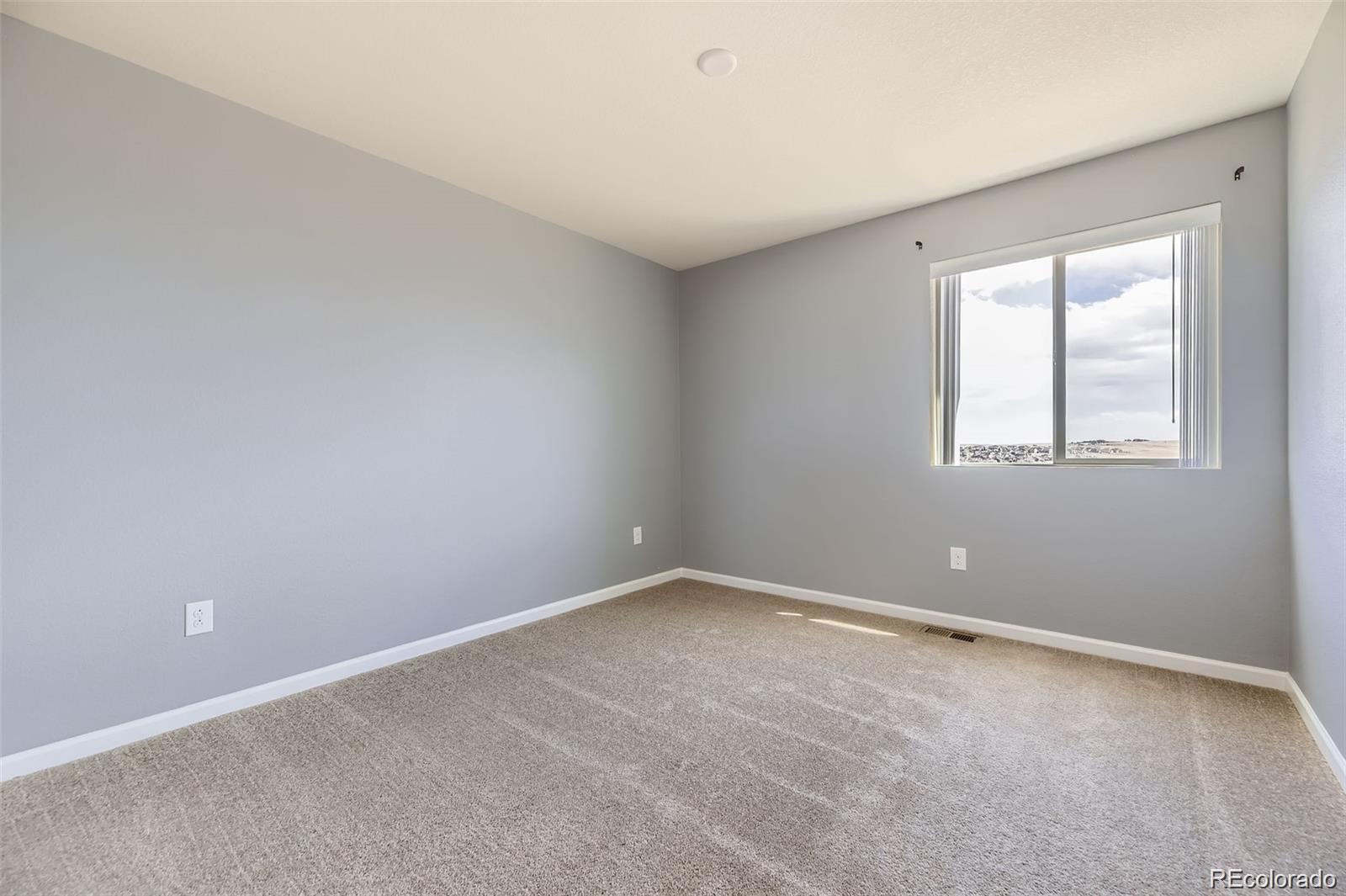 4807 River Highlands Loop Elizabeth, CO 80107 - Photo 20 of 37 an empty room with windows