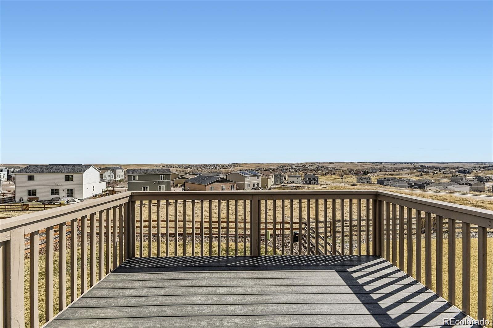 4807 River Highlands Loop Elizabeth, CO 80107 - Photo 25 of 37 a view of a balcony with wooden floor