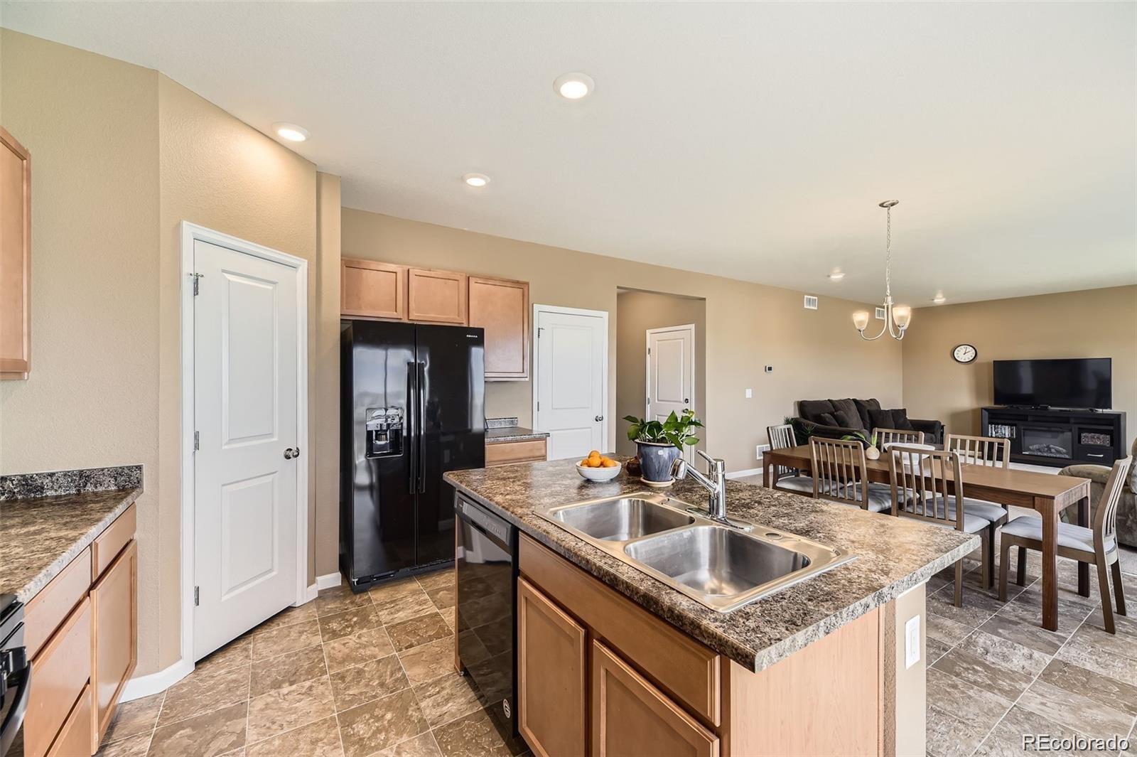 4807 River Highlands Loop Elizabeth, CO 80107 - Photo 6 of 37 a kitchen with stainless steel appliances granite countertop a sink a stove and a refrigerator