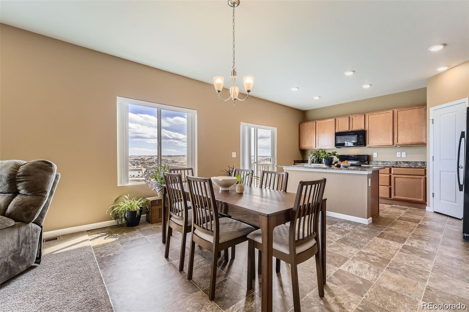 4807 River Highlands Loop Elizabeth, CO 80107 - Photo 7 of 37 a view of a dining room with furniture and a chandelier