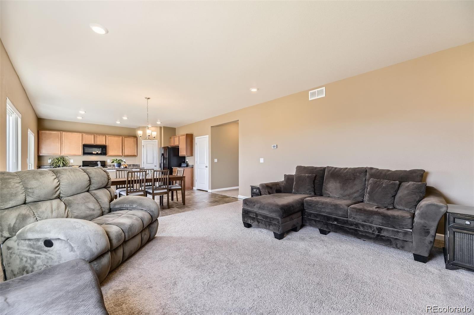 4807 River Highlands Loop Elizabeth, CO 80107 - Photo 10 of 37 a living room with furniture white and kitchen view