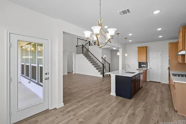 a view of a livingroom with kitchen and furniture