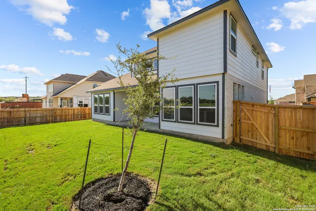 a view of a house with backyard and porch
