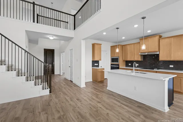 a view of kitchen with cabinets and wooden floor