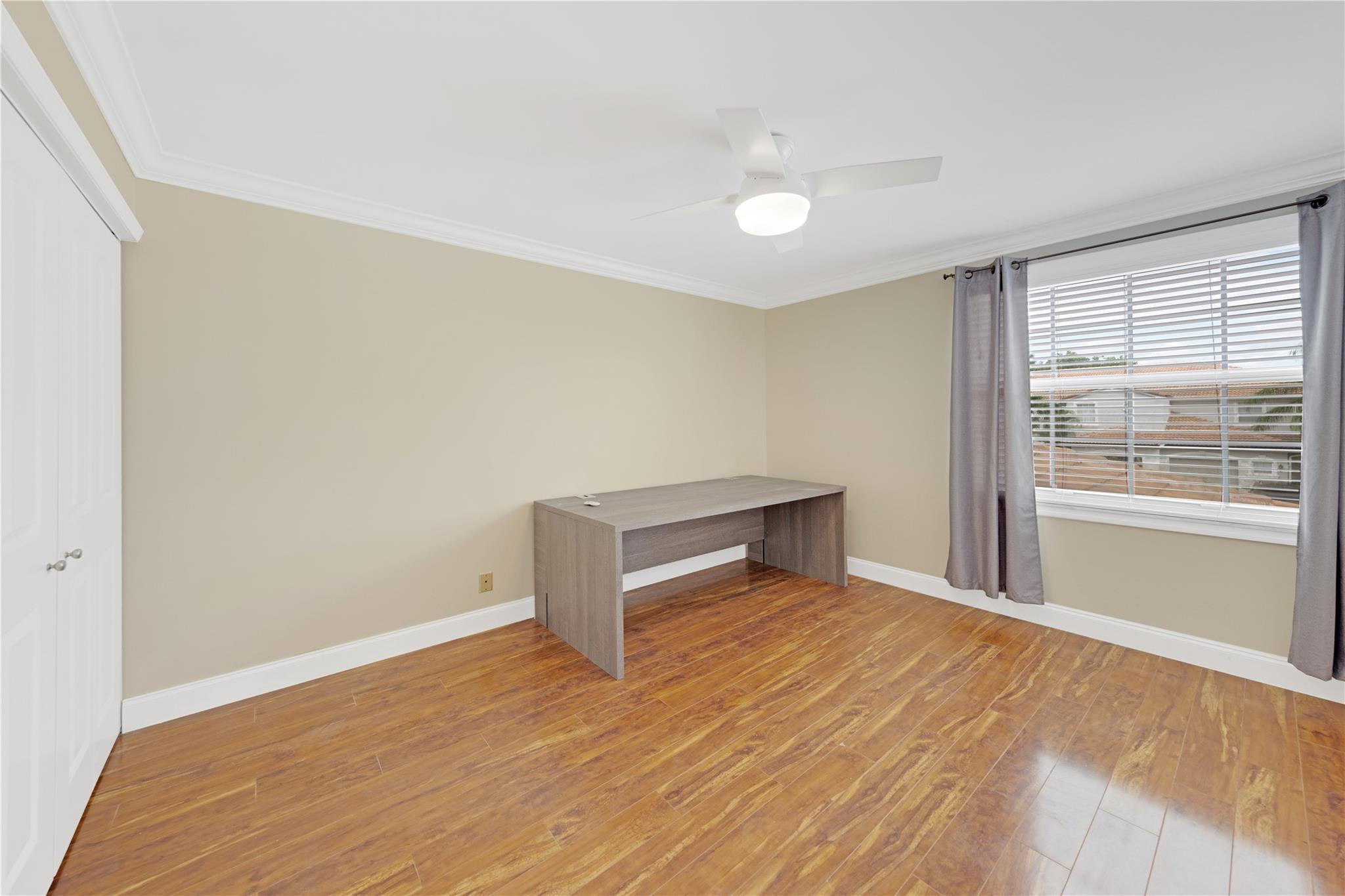 8310 Via Leonessa Boca Raton, FL 33433 - Photo 18 of 29 a view of an empty room with wooden floor and a window