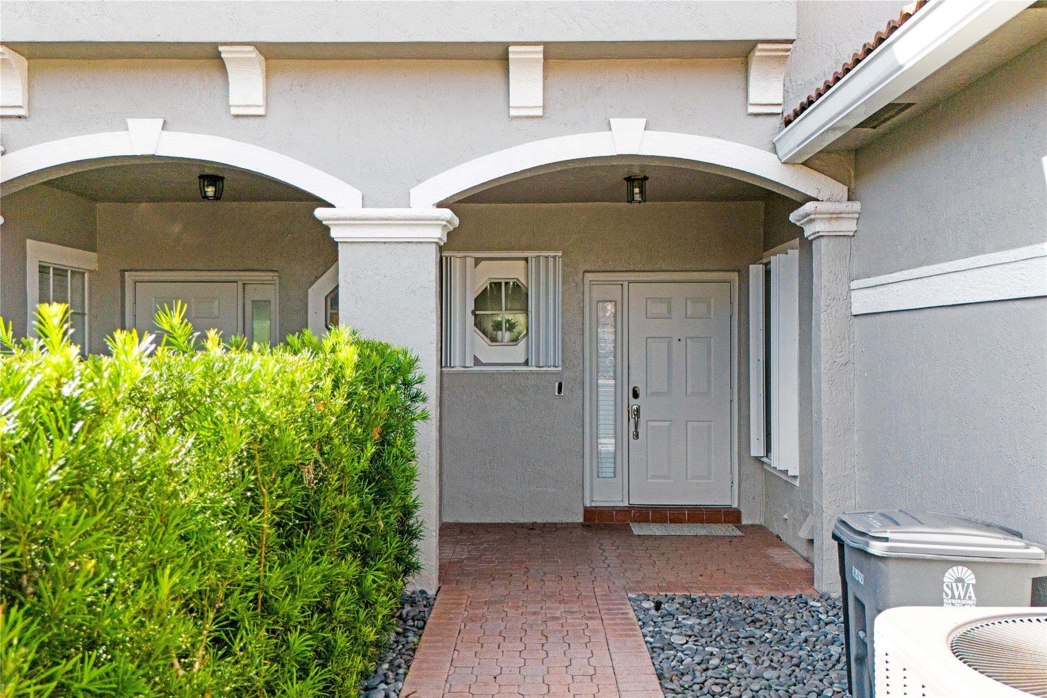 8310 Via Leonessa Boca Raton, FL 33433 - Photo 23 of 29 a front view of a house with garden