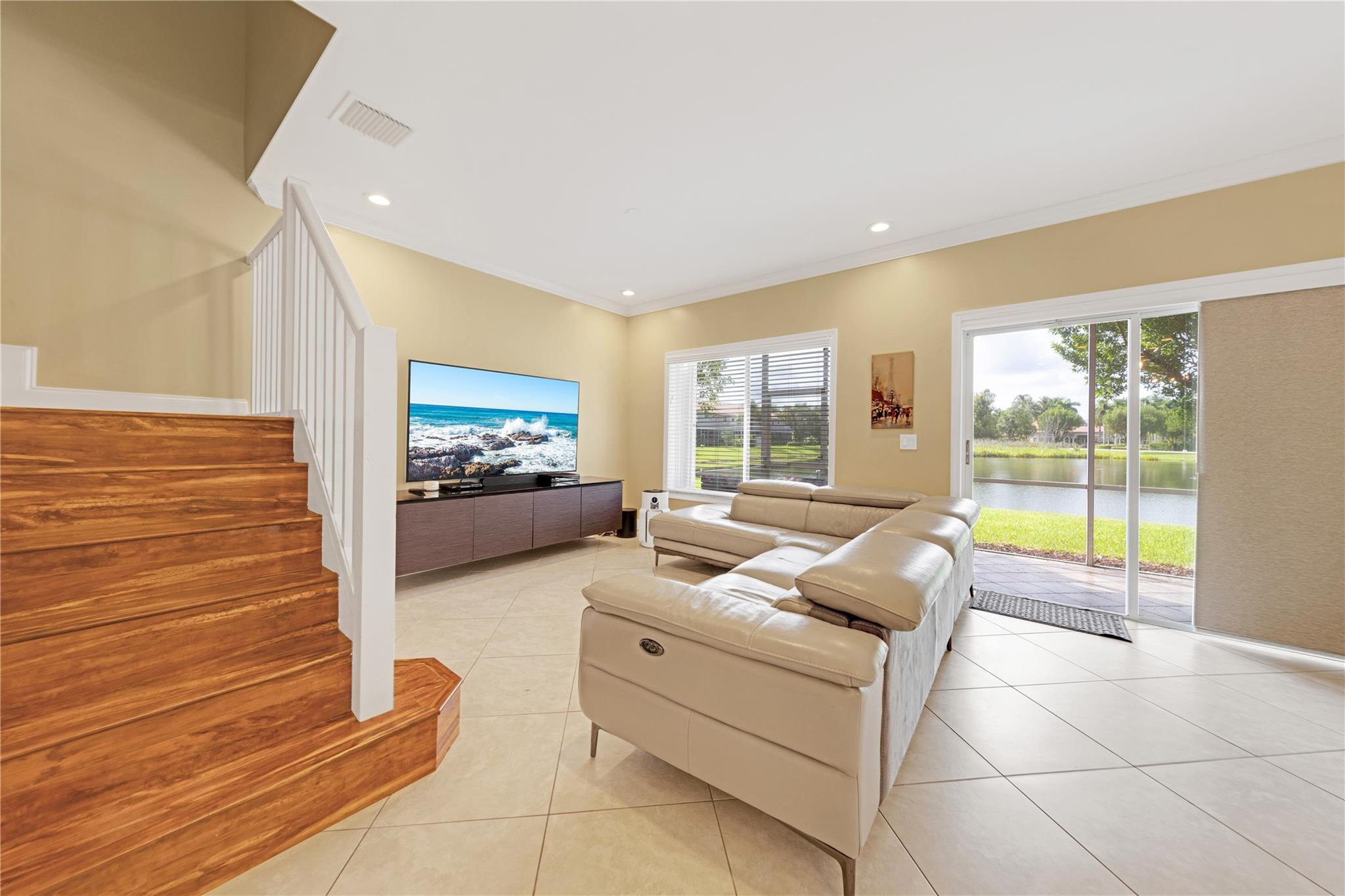 8310 Via Leonessa Boca Raton, FL 33433 - Photo 4 of 29 a living room with furniture large windows and a flat screen tv