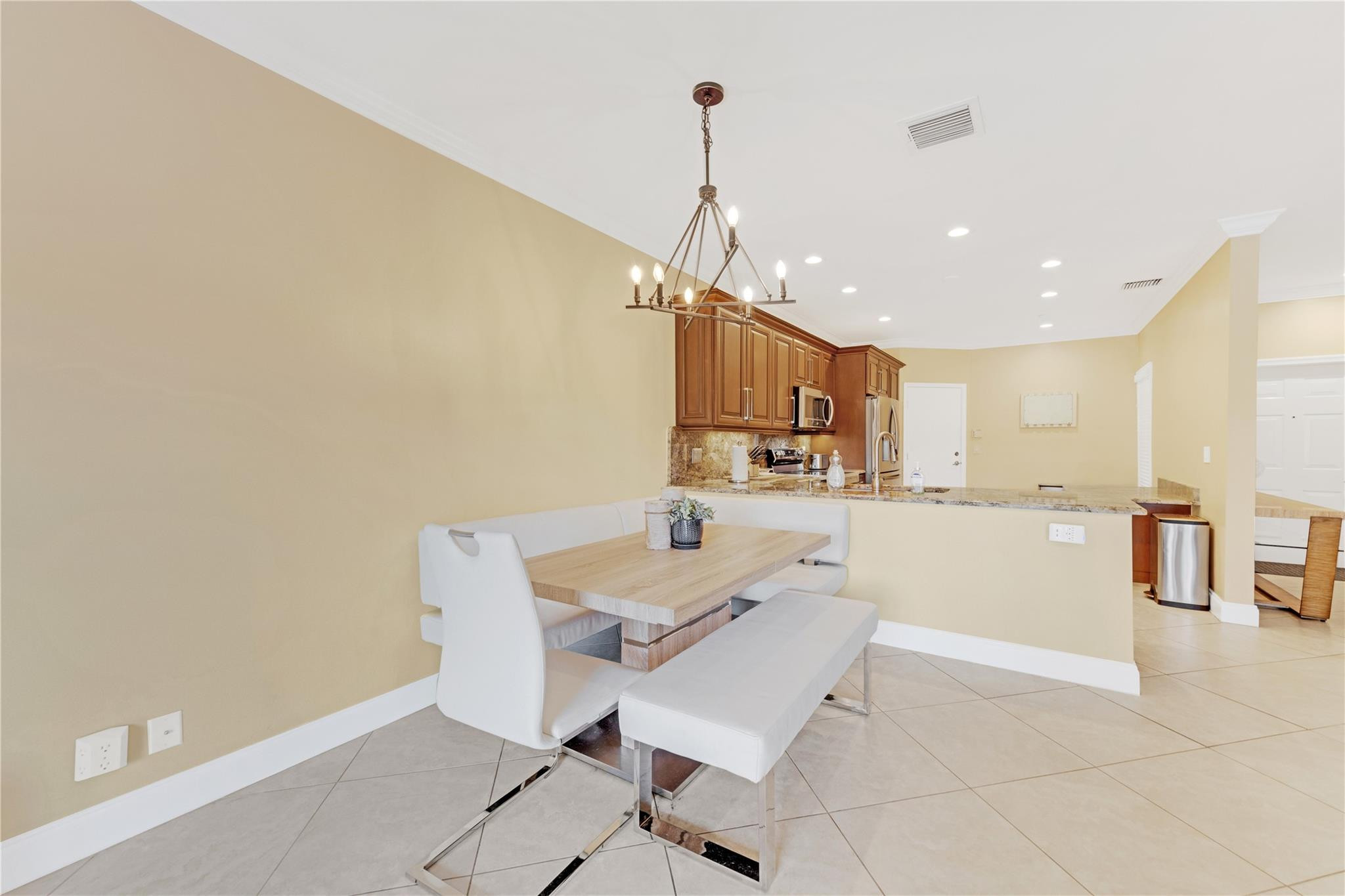 8310 Via Leonessa Boca Raton, FL 33433 - Photo 5 of 29 a room with table chairs and kitchen view