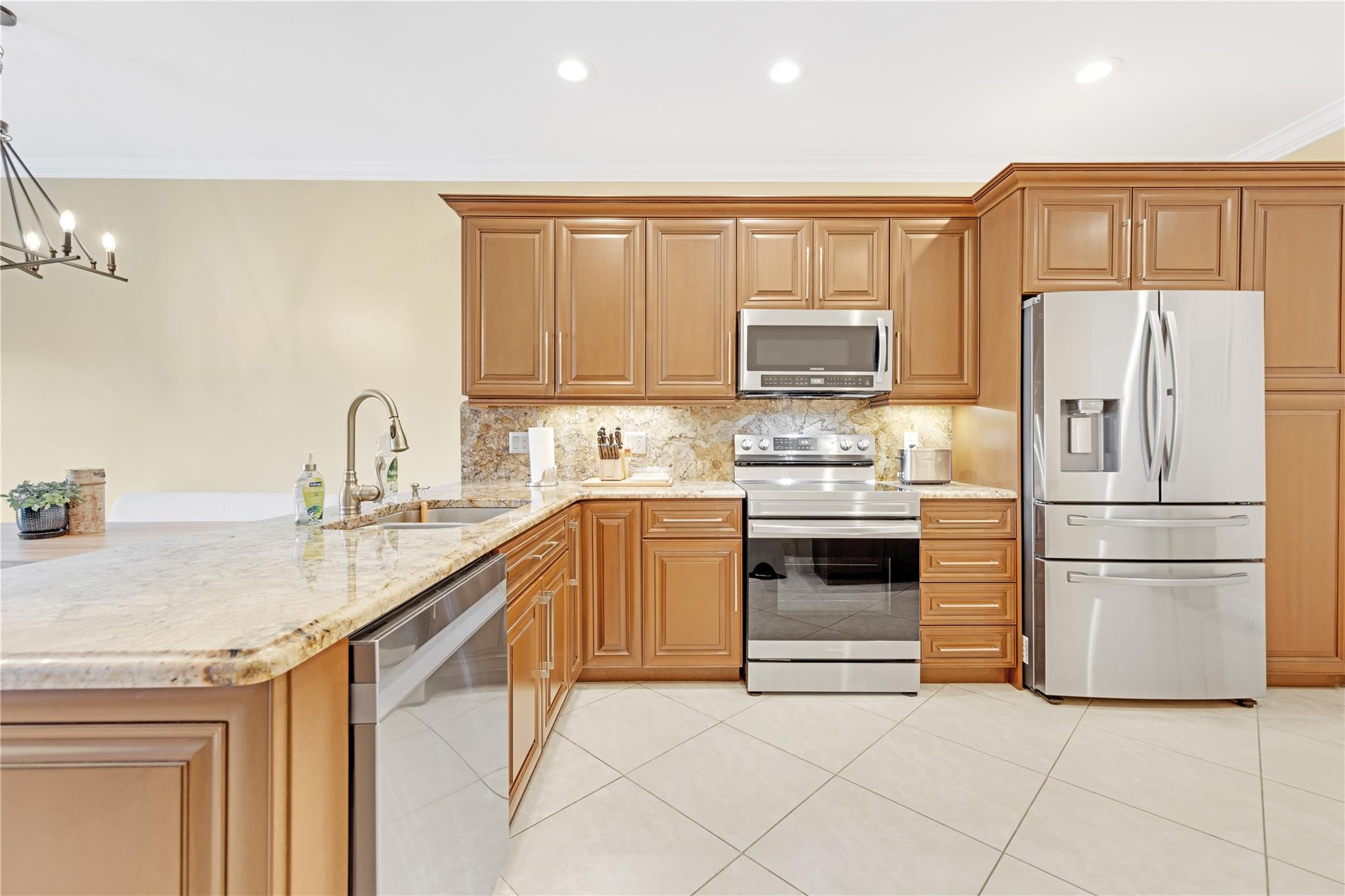 8310 Via Leonessa Boca Raton, FL 33433 - Photo 6 of 29 a kitchen with granite countertop a refrigerator stove top oven and sink