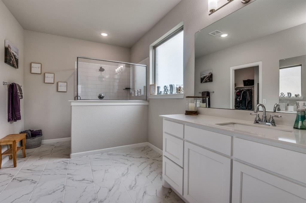 153 Arrow Wood Road Waxahachie, TX 75165 - Photo 11 of 29 The ensuite bathroom features a large shower and a walk in closet