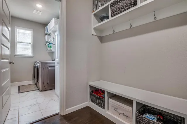 a view of walk in closet with clothes