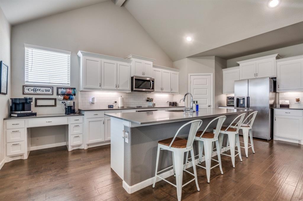 153 Arrow Wood Road Waxahachie, TX 75165 - Photo 2 of 29 Kitchen with an island and a desk area.