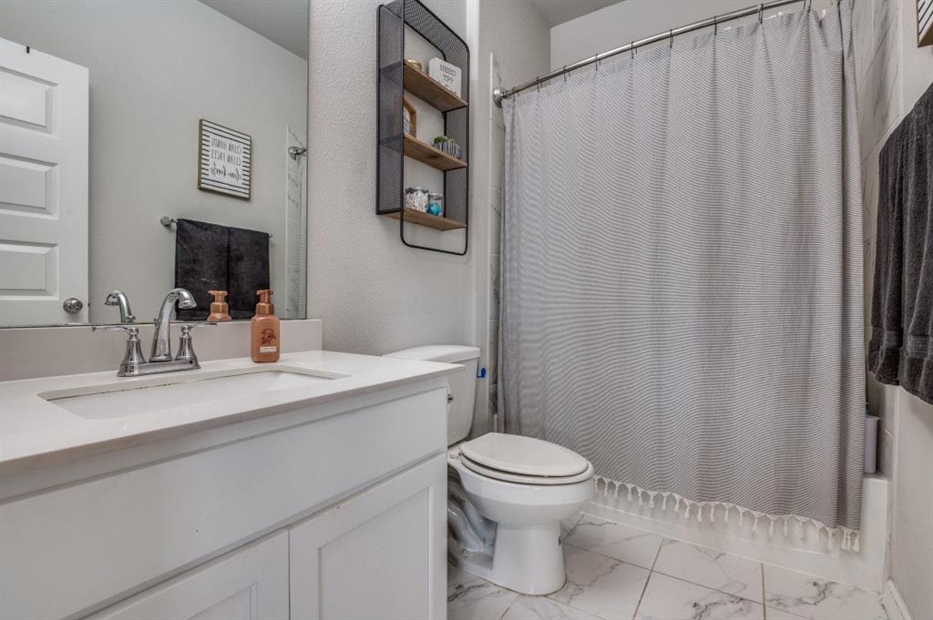153 Arrow Wood Road Waxahachie, TX 75165 - Photo 22 of 29 Full bath with marble finish floors, vanity, and shower / bath combo