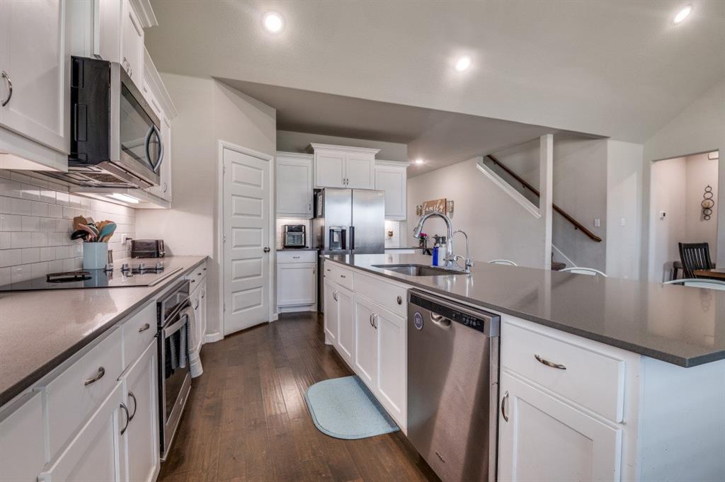 153 Arrow Wood Road Waxahachie, TX 75165 - Photo 3 of 29 Kitchen featuring stainless steel appliances including an electric cooktop. Notice the corner pantry