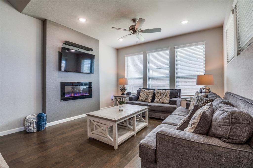 153 Arrow Wood Road Waxahachie, TX 75165 - Photo 7 of 29 Living room featuring a glass fireplace, a ceiling fan and a great view of the back yard.