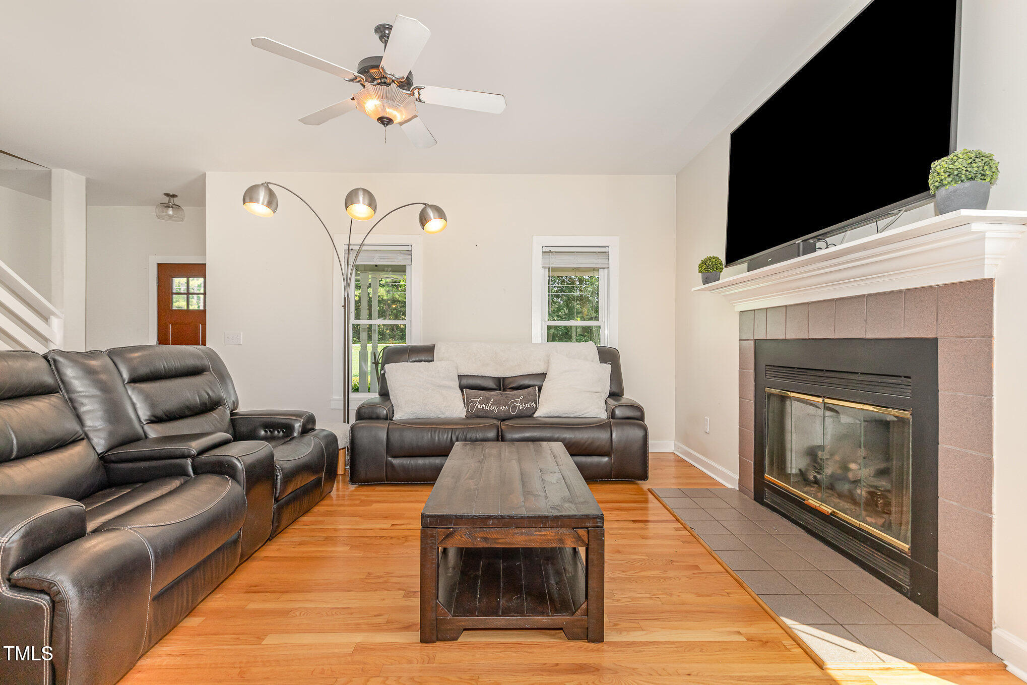 255 Morris Road Pittsboro, NC 27312 - Photo 10 of 40 a living room with furniture a fireplace and a flat screen tv