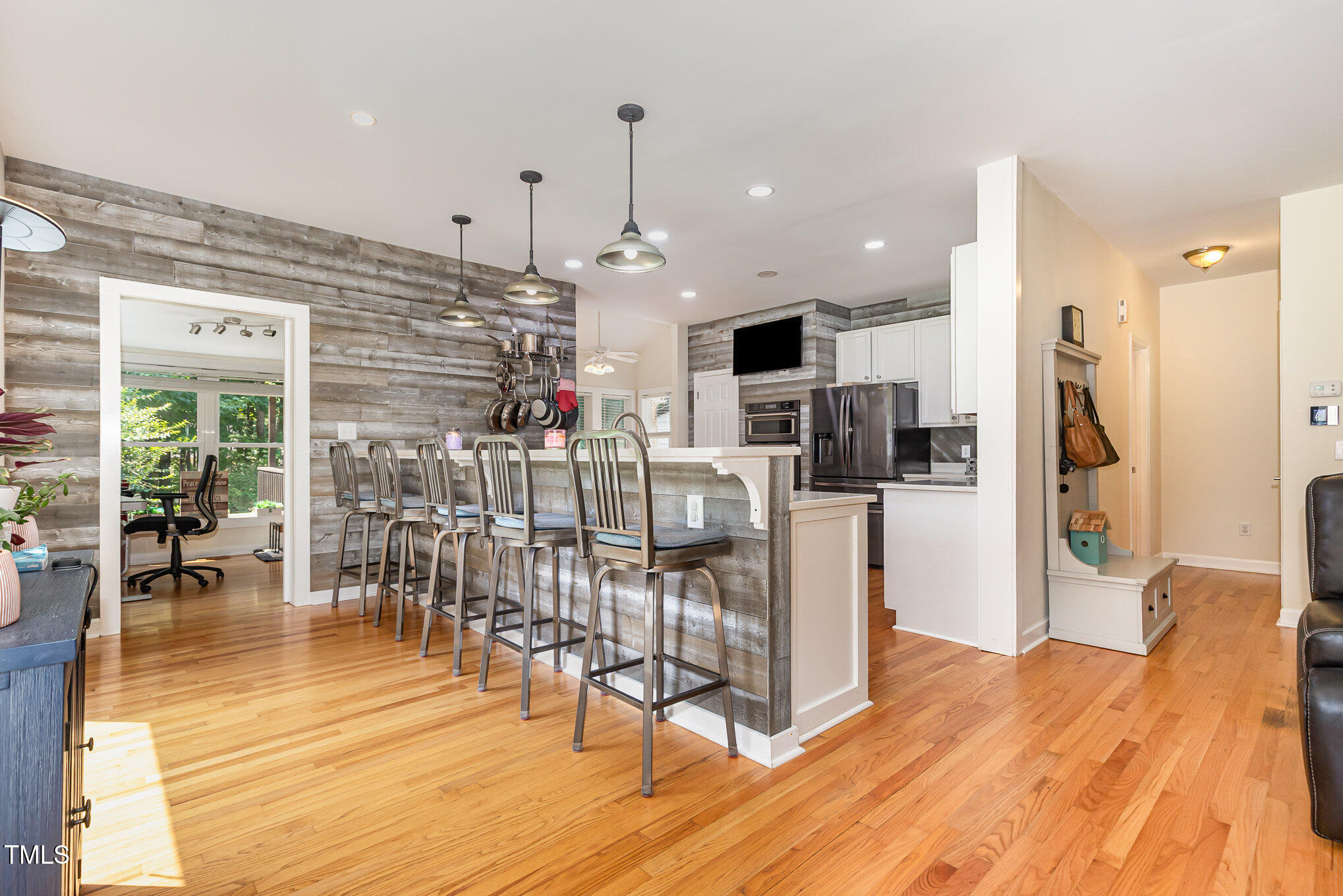 255 Morris Road Pittsboro, NC 27312 - Photo 12 of 40 a kitchen with stainless steel appliances kitchen island granite countertop a refrigerator a stove a dining table and chairs with wooden floor