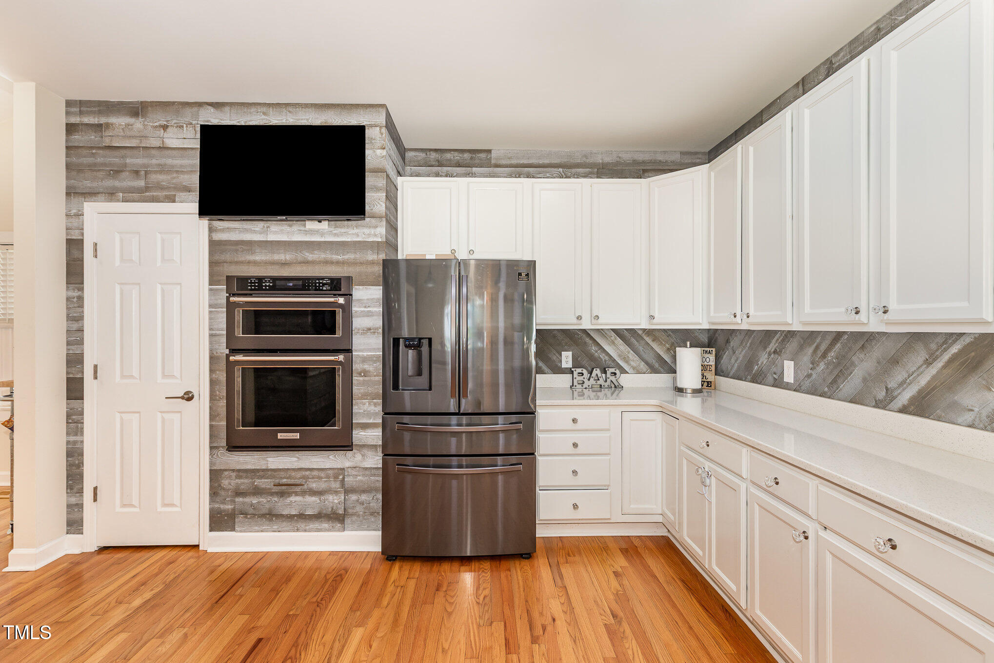 255 Morris Road Pittsboro, NC 27312 - Photo 16 of 40 a kitchen with a refrigerator stove and white cabinets