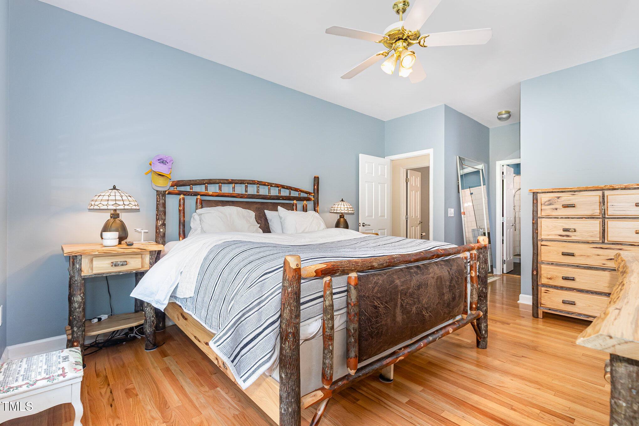 255 Morris Road Pittsboro, NC 27312 - Photo 18 of 40 a bedroom with a bed and a chandelier